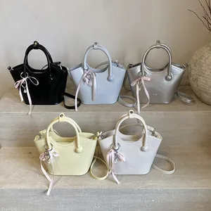 Minimalist summer bucket bags in five colors with silk ribbons and heart charms