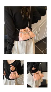 Detailed views of a pink quilted bucket bag with rhinestones, silver chain and pearl charms