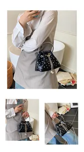 Detail of quilted leather bucket bag with pearls, rivets, and metal ring handle