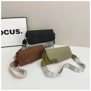 Three minimalist shoulder bags in black, brown, and green with geometric wide straps