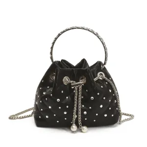 Quilted black bucket bag with rhinestone ring handle and pearl drawstring charms