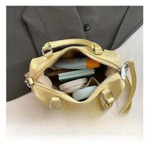 Detail showing the internal storage capacity and crocodile texture of the yellow bowling bag