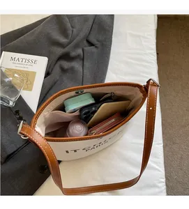 Spacious interior of canvas bucket bag showing organized storage and zipper pocket