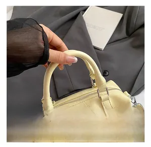 Detail showing the comfortable handle and crocodile pattern on a yellow bowling bag