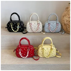 Quilted bowling bags in multiple colors featuring silver rivets and beaded chains