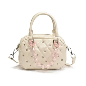 Chic quilted cream bowling bag with pearl chain and bow decoration for women