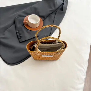 Handwoven straw bucket bag for summer beach holidays with drawstring inner pouch