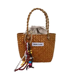 Fashionable brown woven straw handbag with drawstring lining for beach vacation and leisure