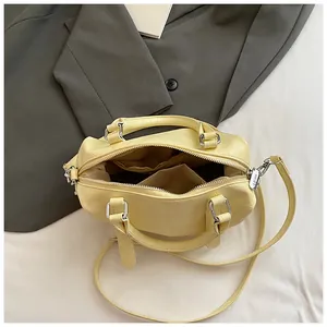 Elegant yellow bowling bag with croc-embossed leather and organized interior pockets