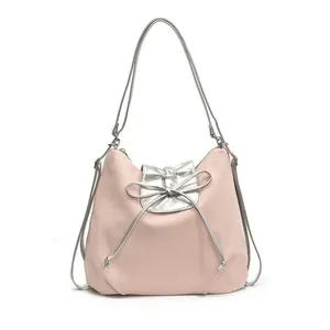 Pink nylon tote bag with silver metallic bow and dual shoulder straps for summer commuting
