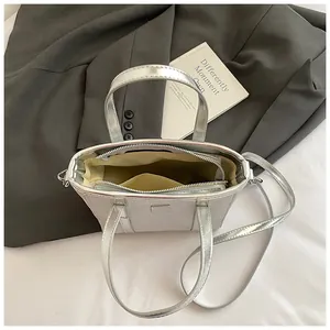 Silver metallic leather tote bag with multiple compartments and detachable strap
