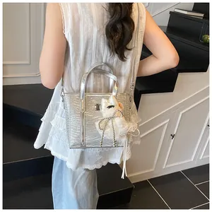 Silver metallic mini tote bag with crocodile embossing and a cute white puppy charm detail