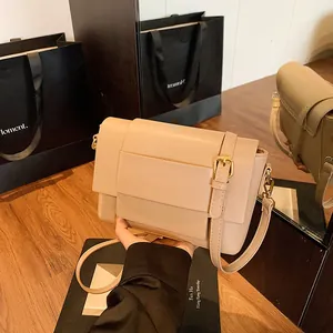 Borsa a tracolla minimalista in pelle beige con fibbia in un ambiente lifestyle raffinato
