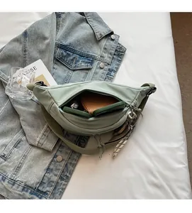 Detail view of light green nylon chest bag interior showing spacious storage capacity