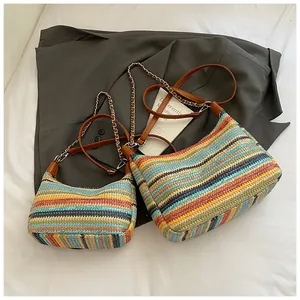 Detailed comparison of large and small multi-colored woven straw tote bags with chain straps