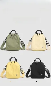 Detail view of mini nylon backpacks in four colors with adjustable wide woven straps