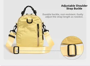 Detail of durable adjustable buckle and textured nylon fabric on yellow shoulder bag