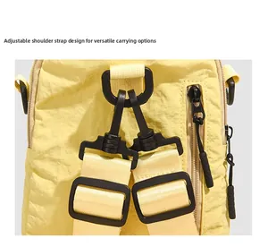 Detail of D-ring and carabiner strap connection on the yellow shell mini backpack
