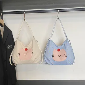 Cartoon tote bags in corduroy and plaid fabrics with cat patches on hangers