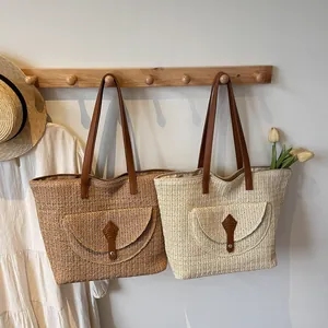 Minimalist straw tote bags with leather handles in brown and beige colors