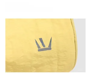 Detailed close-up of light yellow fabric bag showing texture and gray crown logo