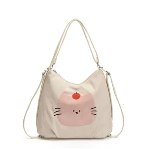 Cartoon cat tote bag made of beige corduroy fabric with adjustable shoulder strap