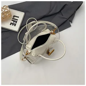 Chic transparent PVC tote bag with cream-white inner pouch and golden hardware accents