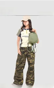 Detail of a grass green mini backpack with adjustable strap on a lifestyle model