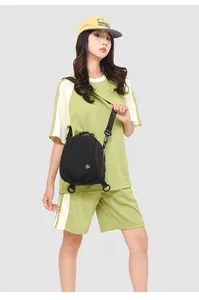 Model wearing a black mini nylon backpack with versatile crossbody and shoulder straps