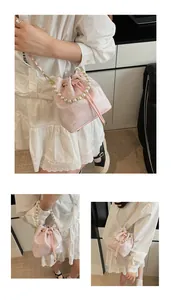 Detailed views of a pink jacquard bucket bag with butterfly patterns and pearl handle