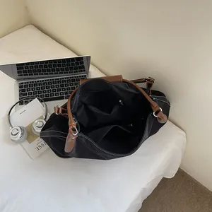 Black nylon tote bag with large capacity and organized compartments for office commute