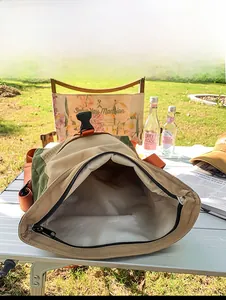 Detail showing the large interior capacity of this khaki and green outdoor tote bag