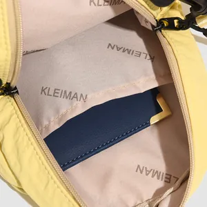 Internal view of yellow nylon shell backpack featuring beige lining and navy card slot