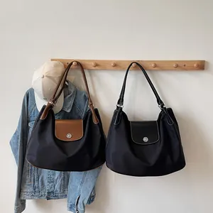Spacious nylon tote bags in black and brown with leather flaps for daily commute