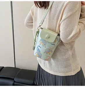 Detail of light green mini crossbody bag with elephant print and star buckle ornament