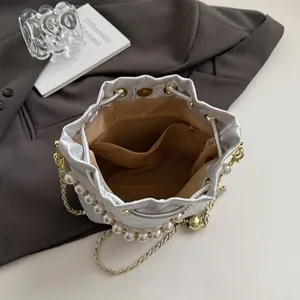 Elegant bucket bag in silver jacquard fabric with pearl chain and golden metal charms