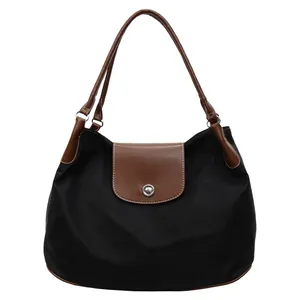 Classic black nylon tote bag with brown leather trim and metal snap button closure