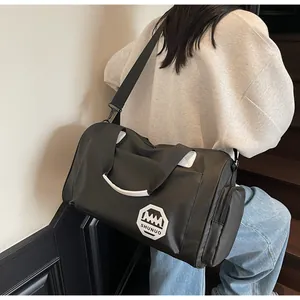 Dettaglio della grande borsa tote nera con tasca laterale a zip e tracolla regolabile