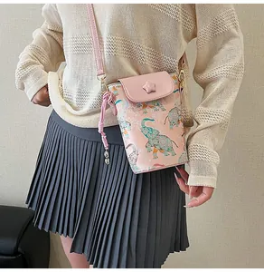 Detail of light pink crossbody phone bag with ethnic elephant print and star buckle