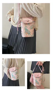 Detail of pink PU leather mini bag with elephant print and a 3D star on the flap
