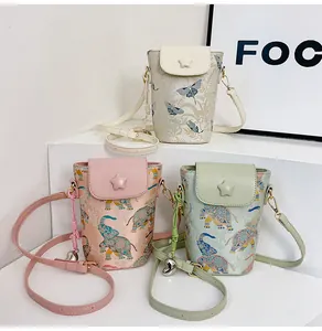 Detailed view of mini crossbody phone bags with star emblem and adjustable leather straps