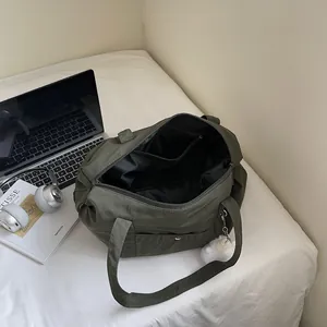 Army green large capacity nylon tote bag with inner compartments and plush ball charm