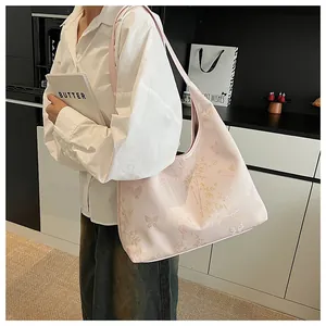 Close-up of pink tote bag featuring elegant butterfly and bamboo floral prints