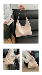 Detail of light pink hobo bag with golden butterfly and bamboo leaf prints and shoulder strap