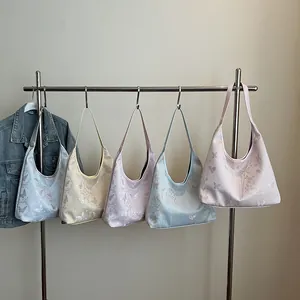 Pastel hobo bags with butterfly floral prints in five colors on a display rack