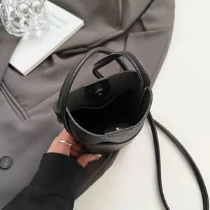 Minimalist black lychee leather mini crossbody bag for women with top handles