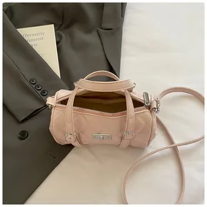 Sac Boston cylindrique matelassé rose avec fermoir rotatif argenté et bandoulière