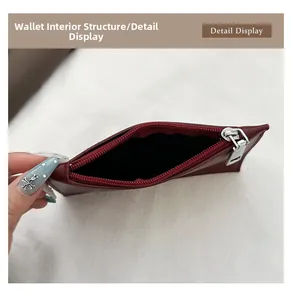 Internal view of dark red leather bucket bag with silver zipper and black lining