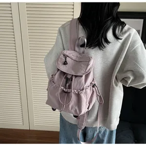 Detail of light purple nylon backpack with drawstring closure and buckle for outdoor use