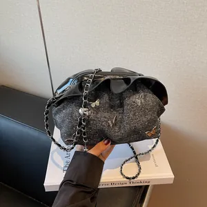Elegant bucket bag in dark grey tweed with ruffle trim and 3D butterfly ornaments